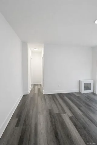 a view of an empty room and wooden floor