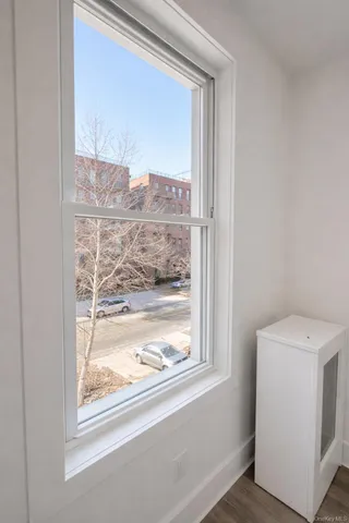 a view of wooden floor and windows in a room