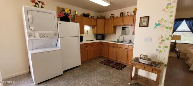 a white refrigerator freezer sitting inside of a kitchen