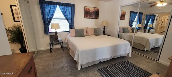 a bedroom with double bed and a window