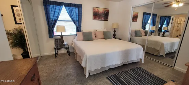 a bedroom with double bed and a window