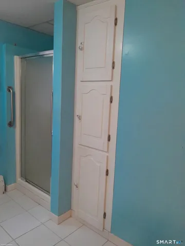 a white toilet sitting next to a bath tub