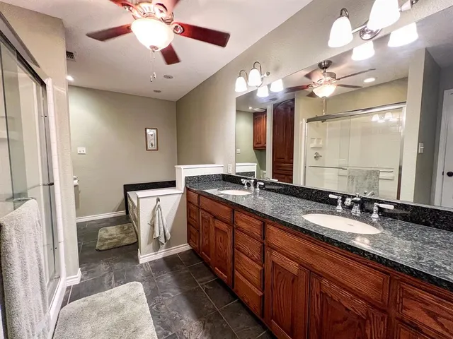a bathroom with a double vanity sink and a mirror