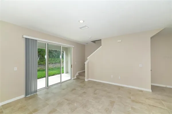 an empty room with floor to ceiling windows and an outdoor view