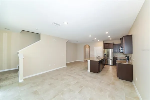 a kitchen with a refrigerator and a couch