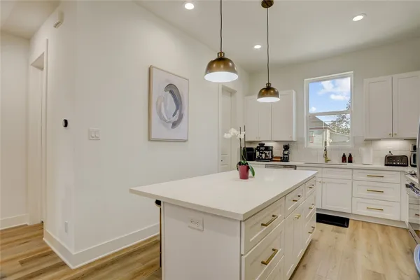 a kitchen with a sink a cabinets and window