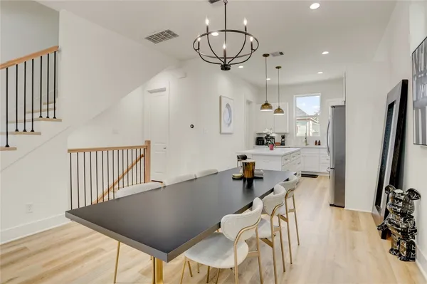 a view of a dining room with furniture wooden floor and a chandelier