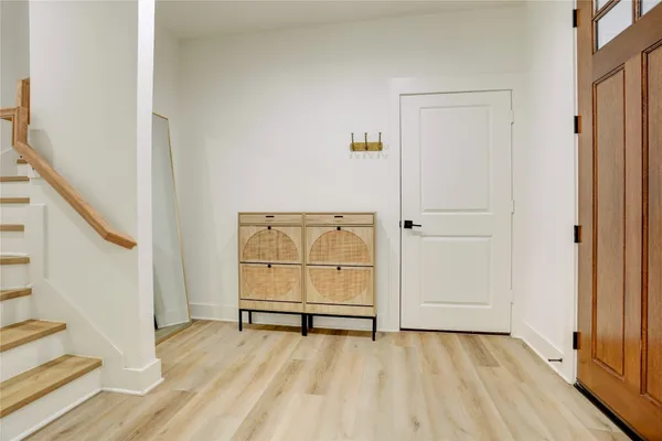 a view of a room with wooden floor and cabinet