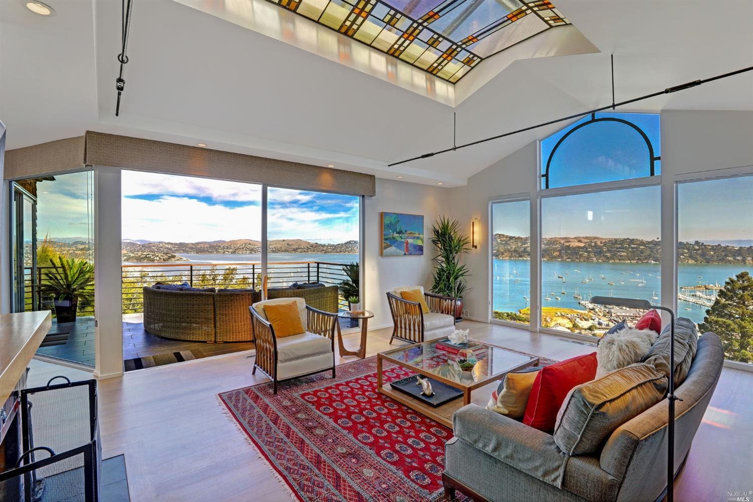 a living room with furniture city view and a floor to ceiling window