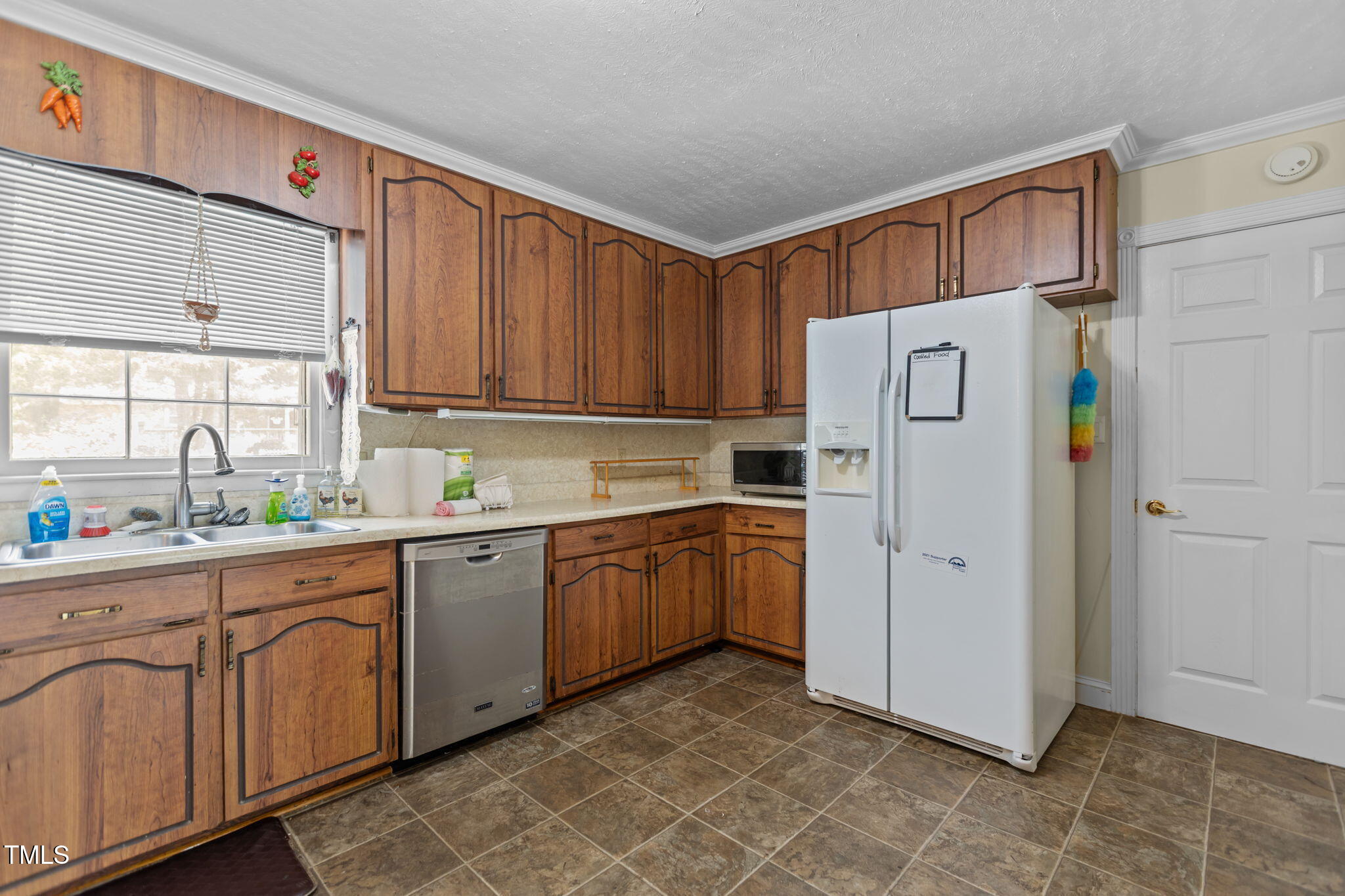 4807 Greenbrier Road Raleigh, NC 27603 - Photo 5 of 40 a kitchen with stainless steel appliances a refrigerator sink and cabinets