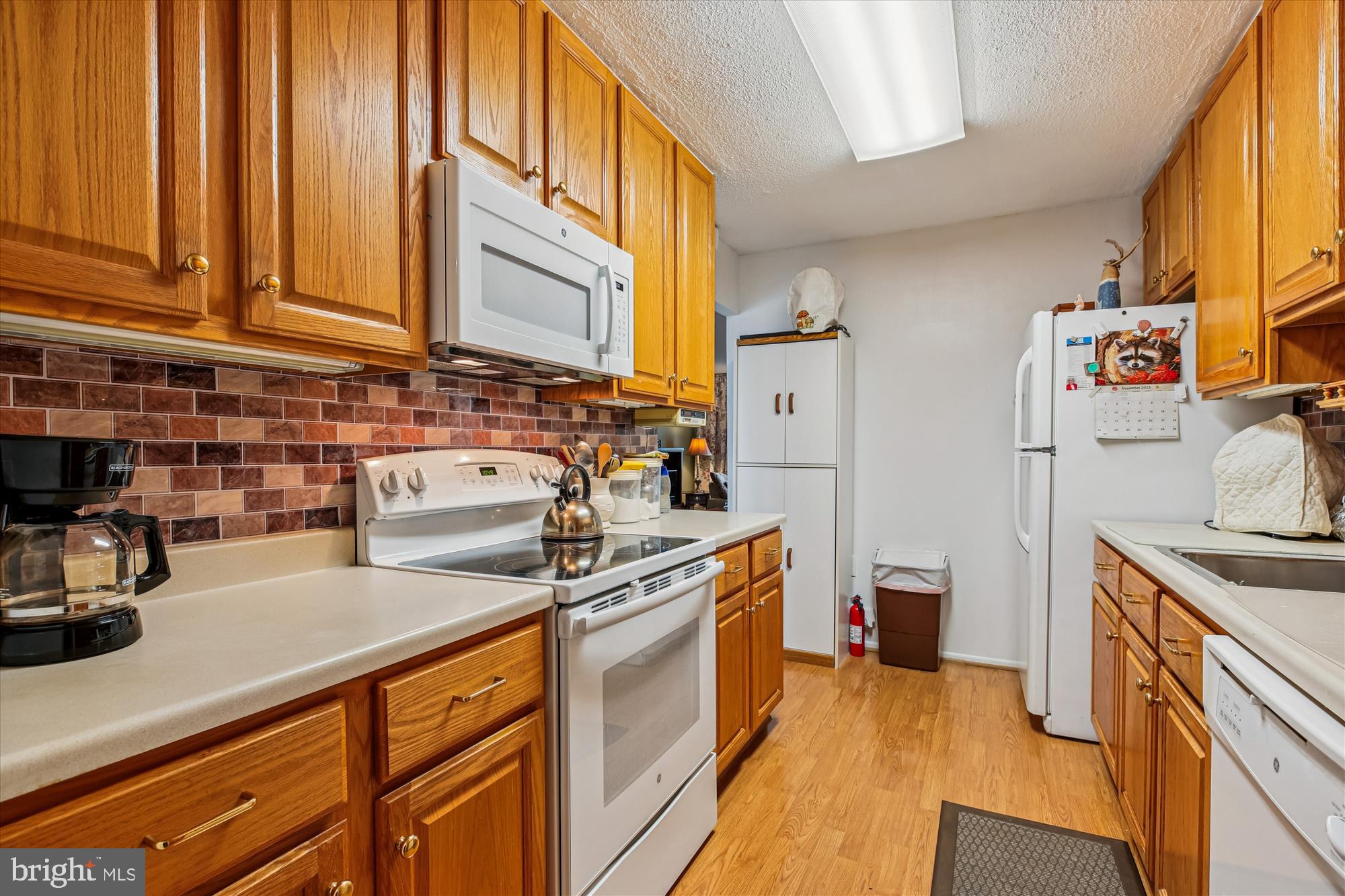 15205 Tottenham Terrace, Unit 24B Silver Spring, MD 20906 - Photo 17 of 33 a kitchen with stainless steel appliances granite countertop a sink stove and refrigerator