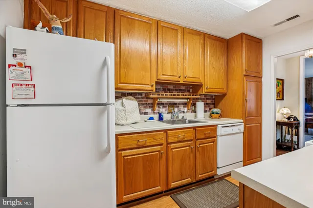 a kitchen with stainless steel appliances a refrigerator sink and cabinets