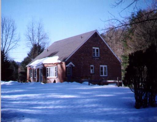 327 Huntington Road Russell, MA 01071 - Photo 1 of 1 a front view of a house with a yard