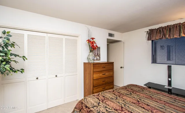 a bedroom with a bed and a dresser