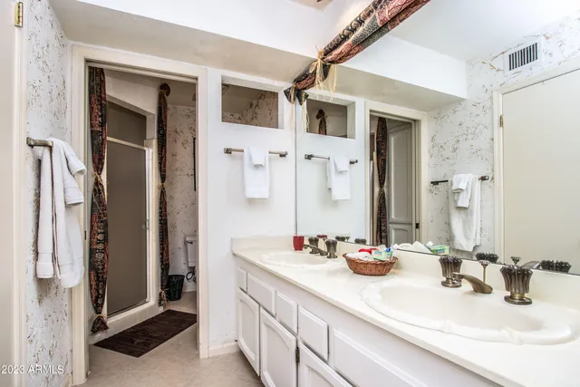 a bathroom with a sink double vanity and a mirror
