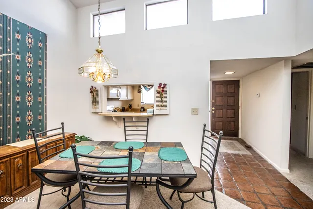 a view of a dining room with furniture and chandelier