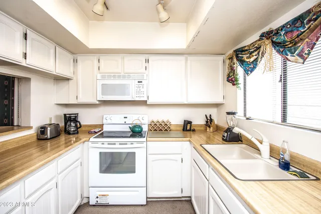 a kitchen with a sink cabinets and window