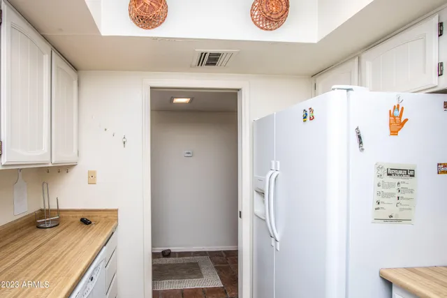 a room with a refrigerator and a sink