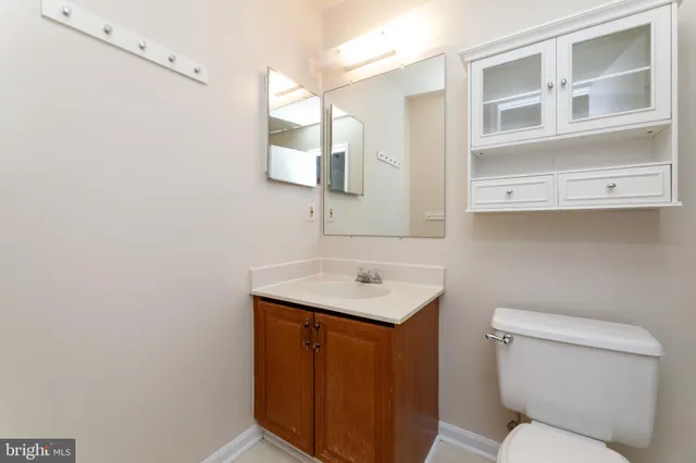 a bathroom with a sink and mirror with window