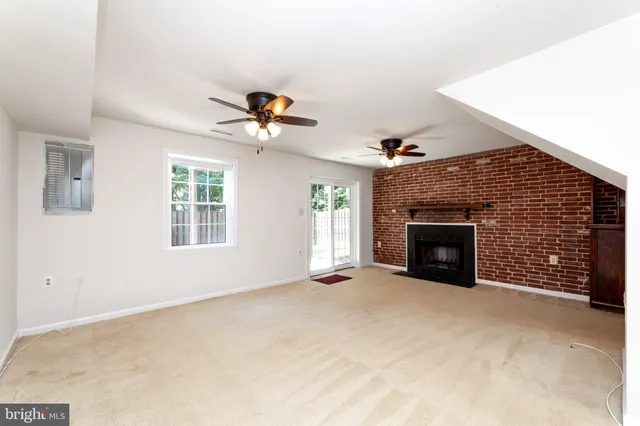 wooden floor in an empty room with a ceiling fan