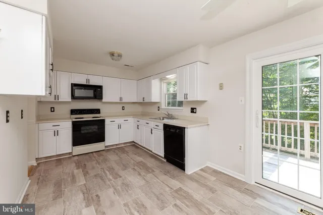 a kitchen with a stove a sink and a microwave