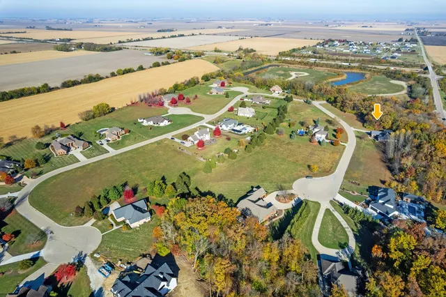 an aerial view of a house with a lake view