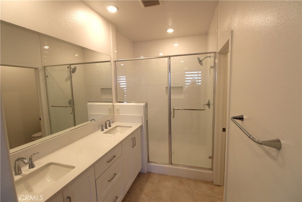 398 Merit Irvine, CA 92618 - Photo 18 of 25 a bathroom with a shower sink and mirror