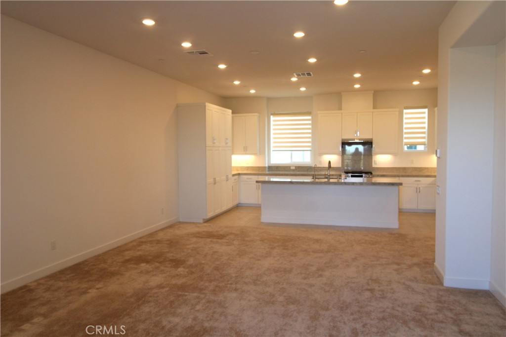 398 Merit Irvine, CA 92618 - Photo 7 of 25 a large kitchen with granite countertop a sink and a white cabinets