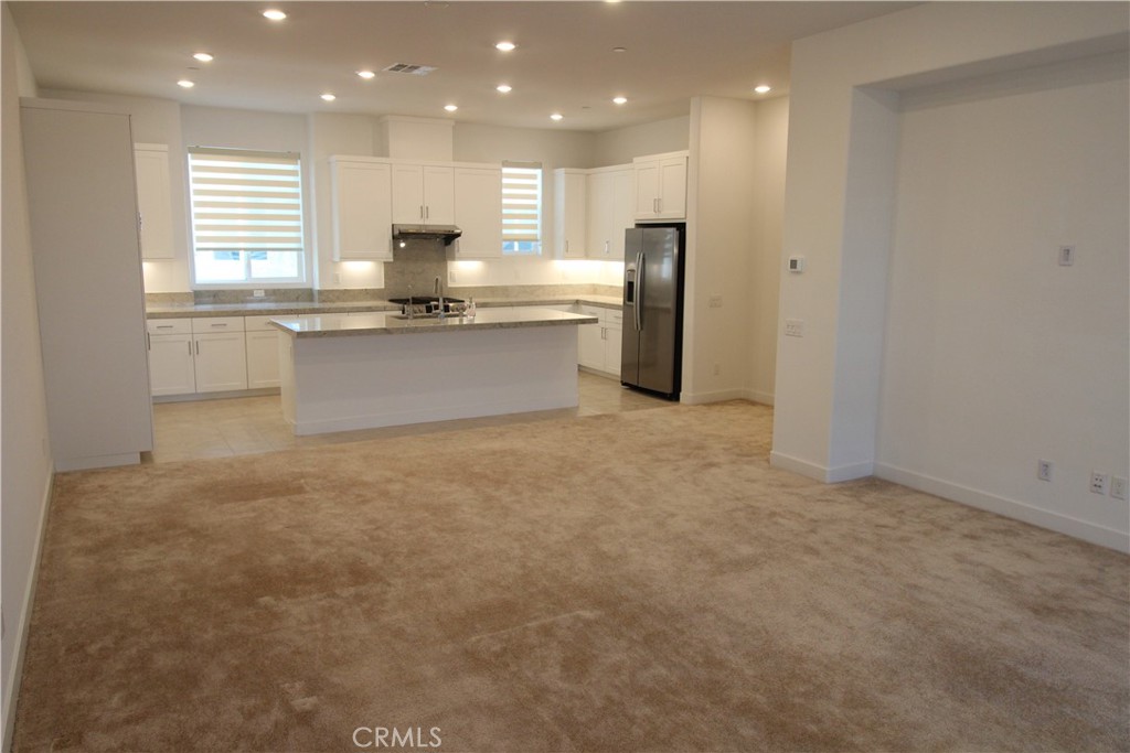 398 Merit Irvine, CA 92618 - Photo 8 of 25 a kitchen with stainless steel appliances granite countertop a sink a stove and a refrigerator