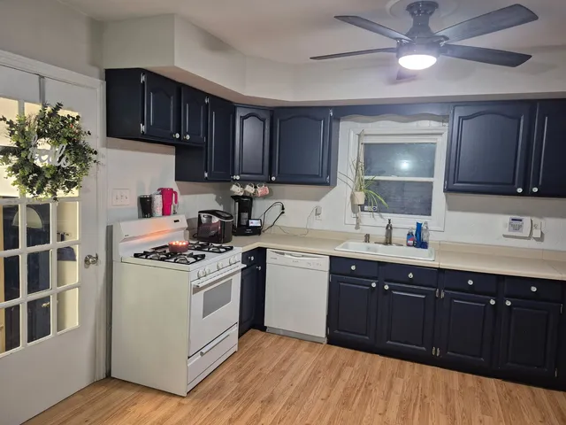a kitchen with a stove a sink and cabinets