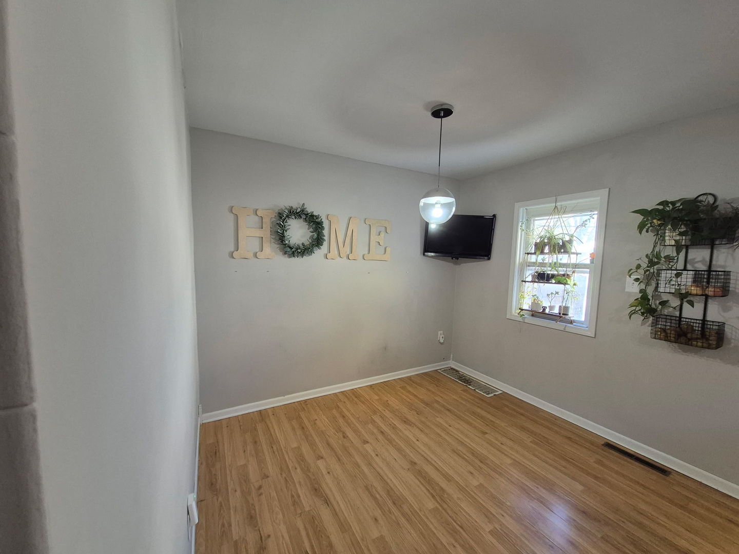 863 West Williams Street Kankakee, IL 60901 - Photo 7 of 14 a view of empty room with wooden floor and fan