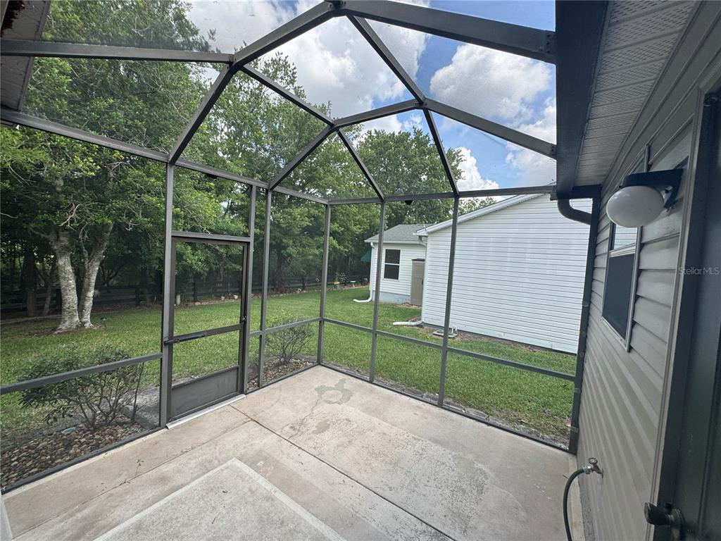 314 Juarez Way Lady Lake, FL 32159 - Photo 16 of 17 a view of a house with backyard and porch