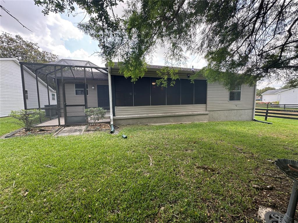 314 Juarez Way Lady Lake, FL 32159 - Photo 17 of 17 a backyard of a house with lots of green space