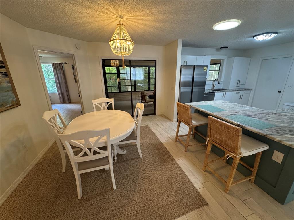 314 Juarez Way Lady Lake, FL 32159 - Photo 3 of 17 a dining room with furniture a chandelier and window