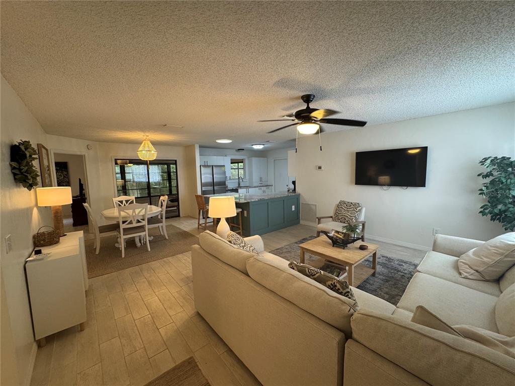 314 Juarez Way Lady Lake, FL 32159 - Photo 4 of 17 a living room with furniture and a flat screen tv