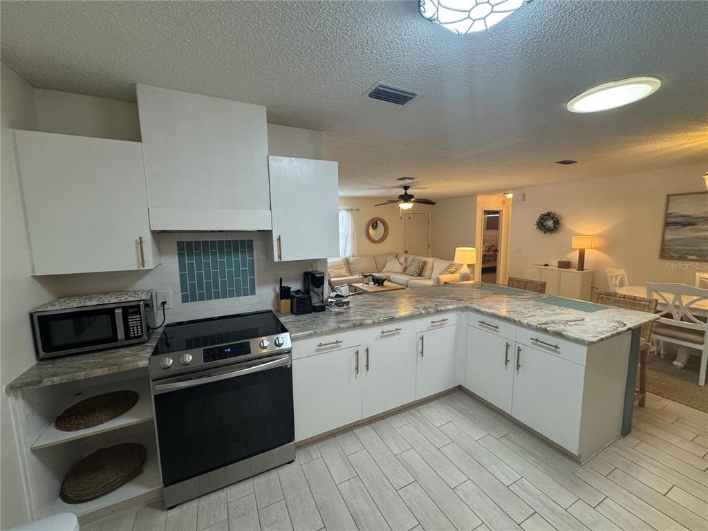 314 Juarez Way Lady Lake, FL 32159 - Photo 7 of 17 a kitchen with a sink stove and cabinets