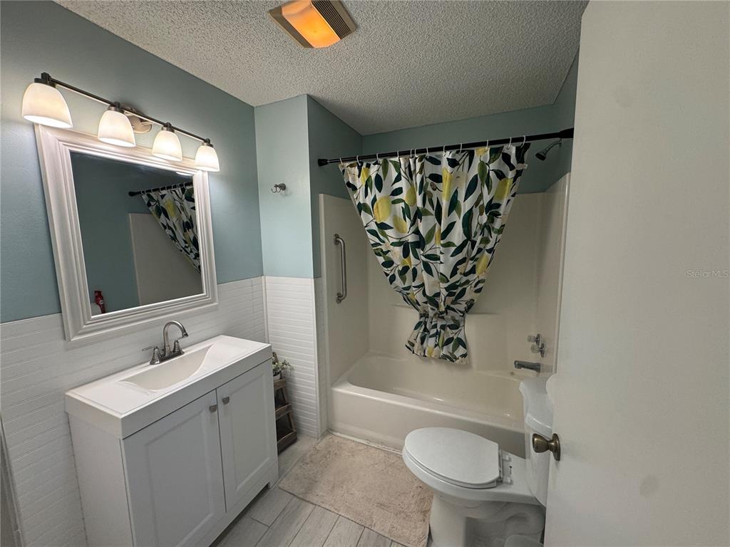 314 Juarez Way Lady Lake, FL 32159 - Photo 9 of 17 a bathroom with a toilet sink and mirror