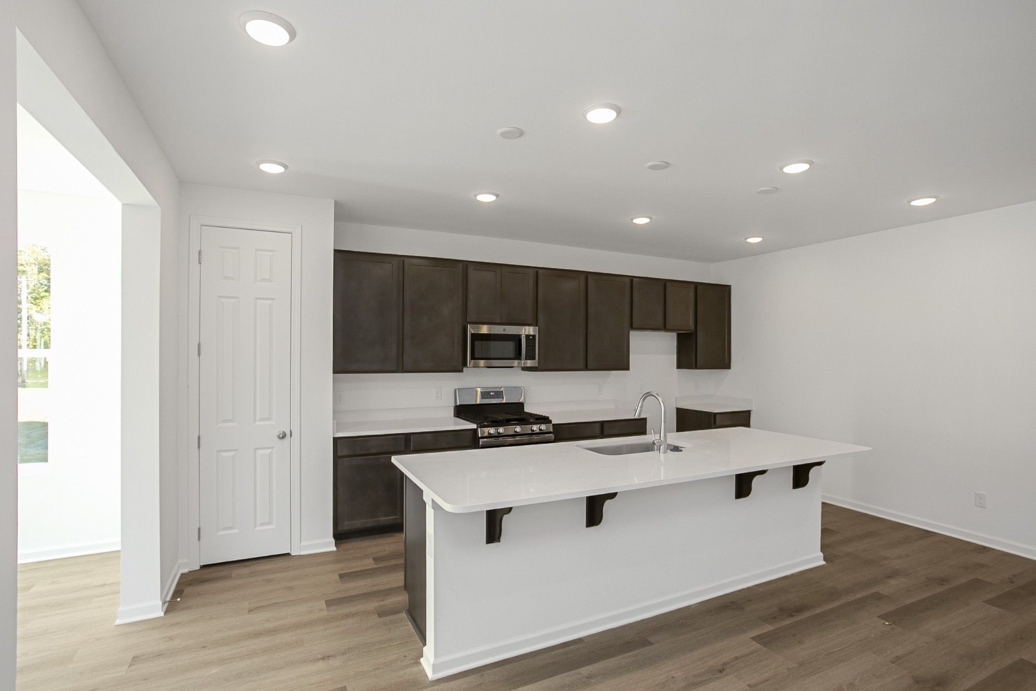 702 West Chestnut Street Dickson, TN 37055 - Photo 13 of 37 a kitchen with kitchen island stainless steel appliances a sink and a refrigerator