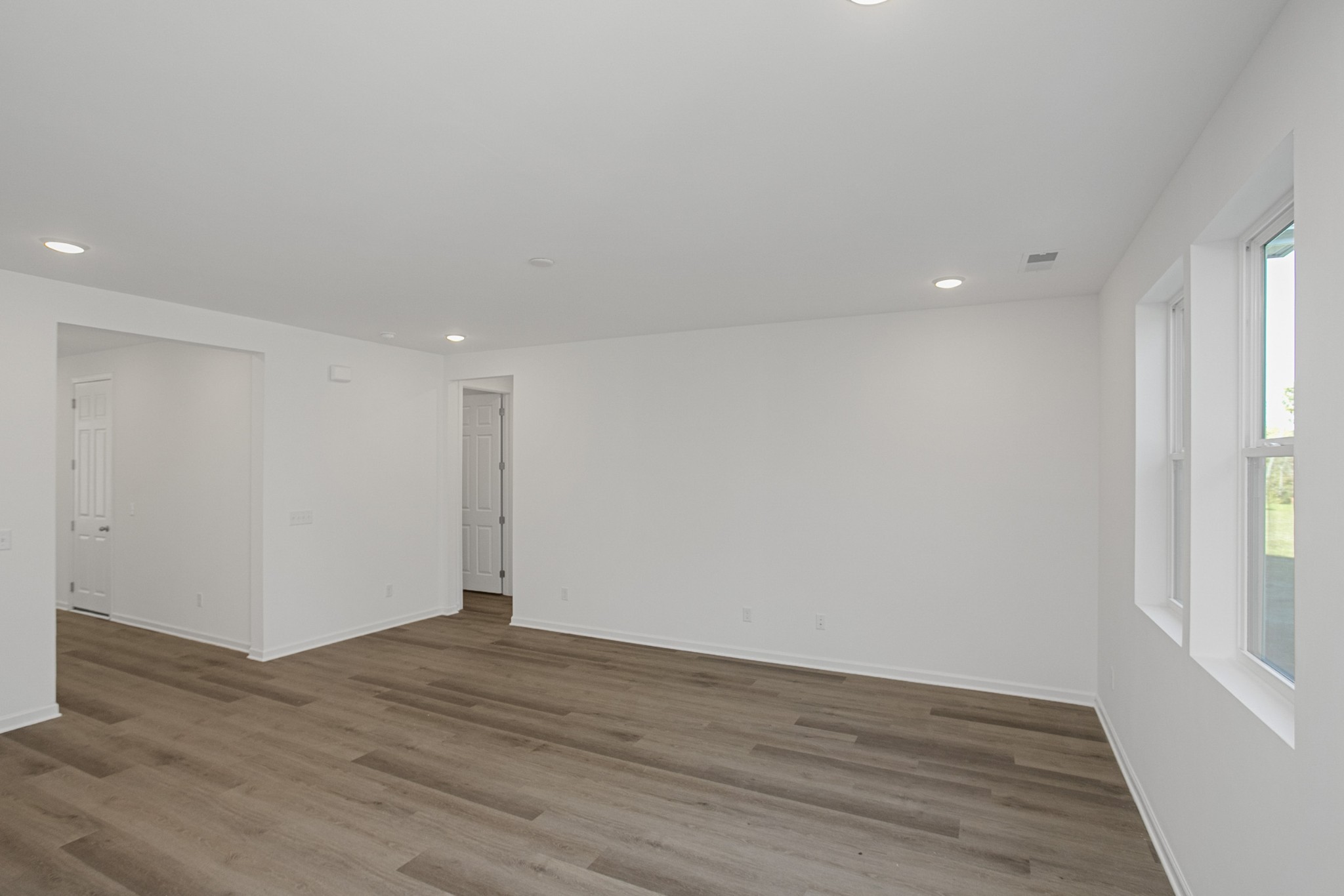 702 West Chestnut Street Dickson, TN 37055 - Photo 14 of 37 a view of an empty room with wooden floor and a window