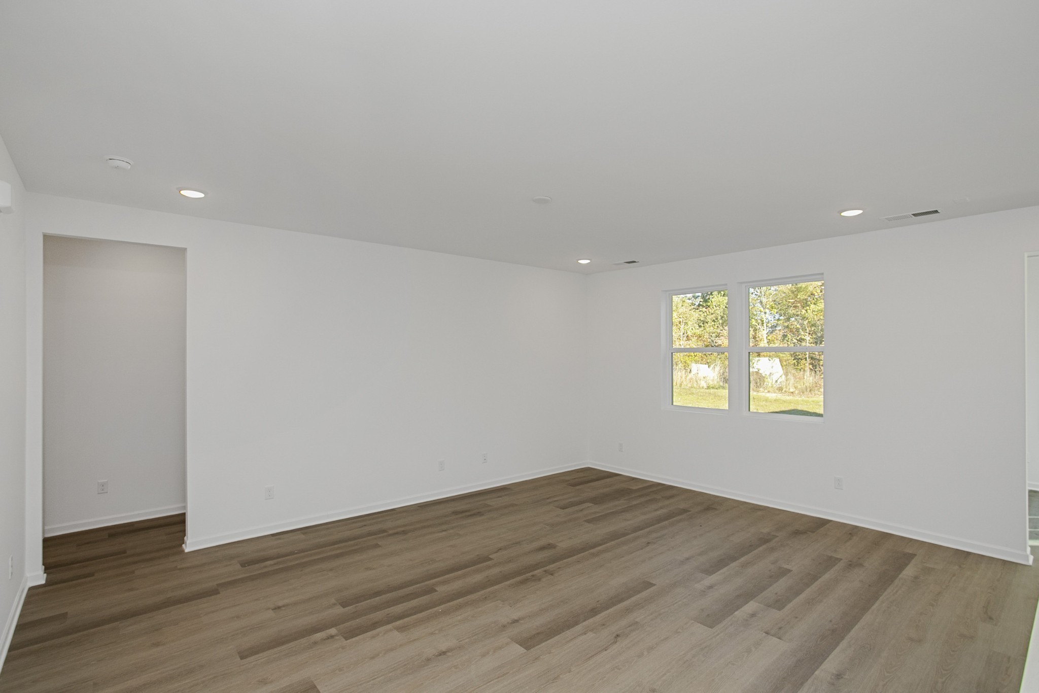702 West Chestnut Street Dickson, TN 37055 - Photo 15 of 37 a view of an empty room with wooden floor and a window