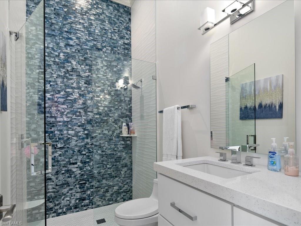 830 Cassena Road Naples, FL 34108 - Photo 15 of 41 a bathroom with a sink a toilet and shower