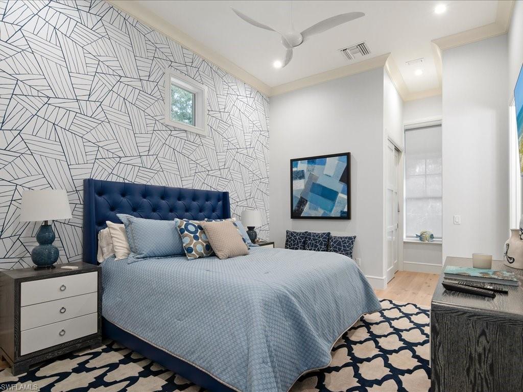 830 Cassena Road Naples, FL 34108 - Photo 16 of 41 a bedroom with a bed and a lamp on dresser