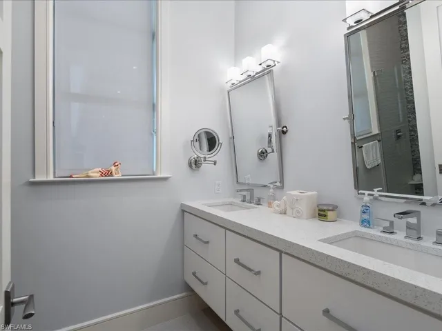 a bathroom with a double vanity sink and mirror