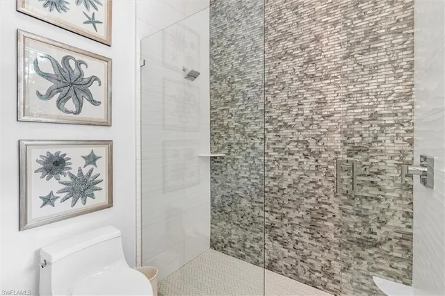 a bathroom with a toilet and a shower curtain