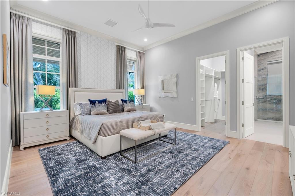 830 Cassena Road Naples, FL 34108 - Photo 21 of 41 a spacious bedroom with a large bed and a couch