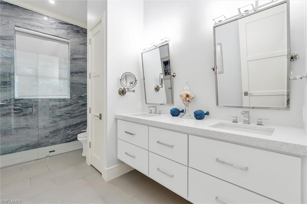 830 Cassena Road Naples, FL 34108 - Photo 22 of 41 a bathroom with a double vanity sink mirror and double