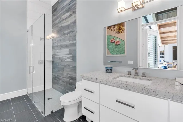 a living room with furniture a flat screen tv and a large window