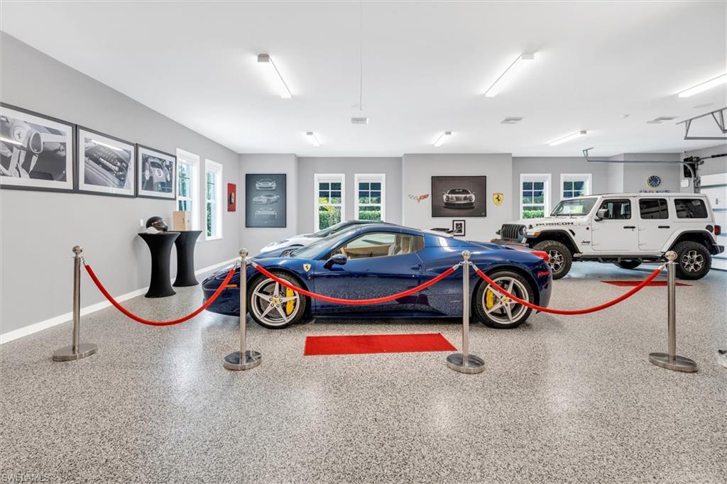 830 Cassena Road Naples, FL 34108 - Photo 28 of 41 a living room with furniture a flat screen tv and a large window