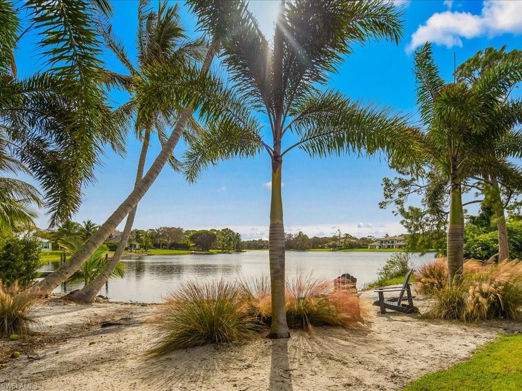 830 Cassena Road Naples, FL 34108 - Photo 32 of 41 a lake view with palm trees