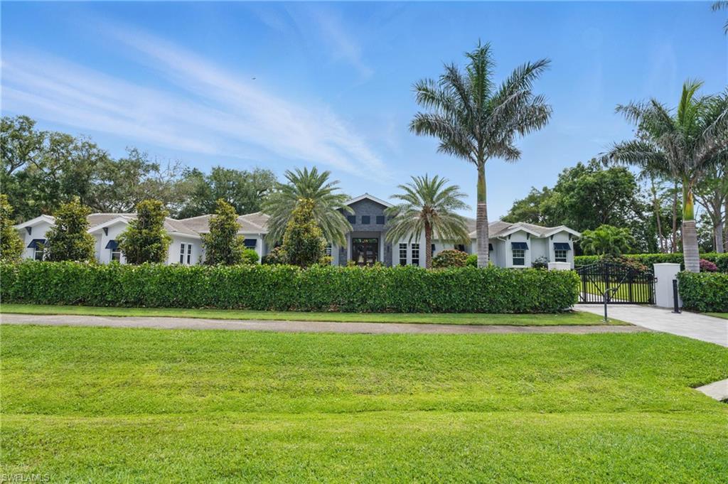 830 Cassena Road Naples, FL 34108 - Photo 37 of 41 a front view of house and yard with green space
